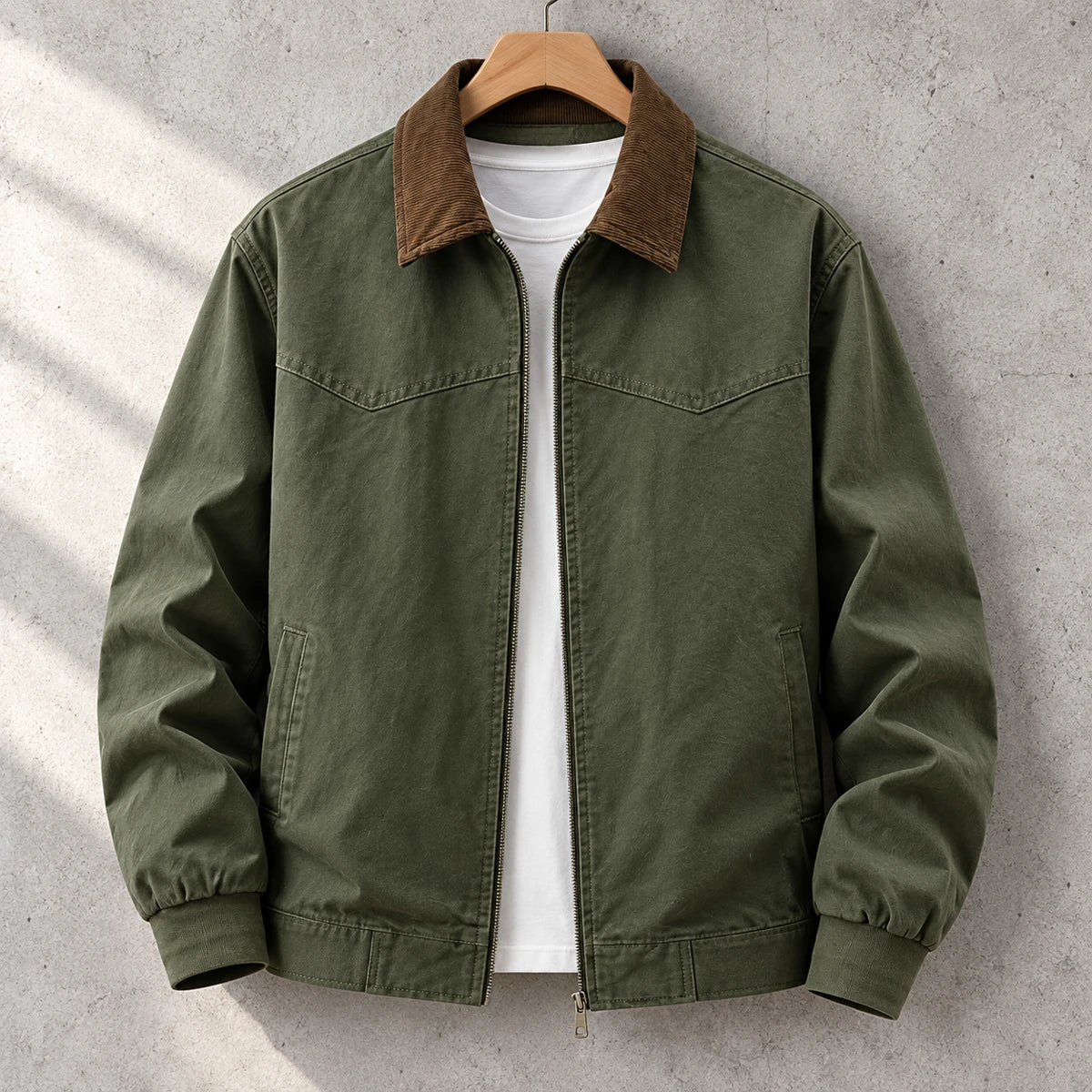Cotton Jacket | Bennett Green front garment hanging on simple wooden hanger on concrete wall