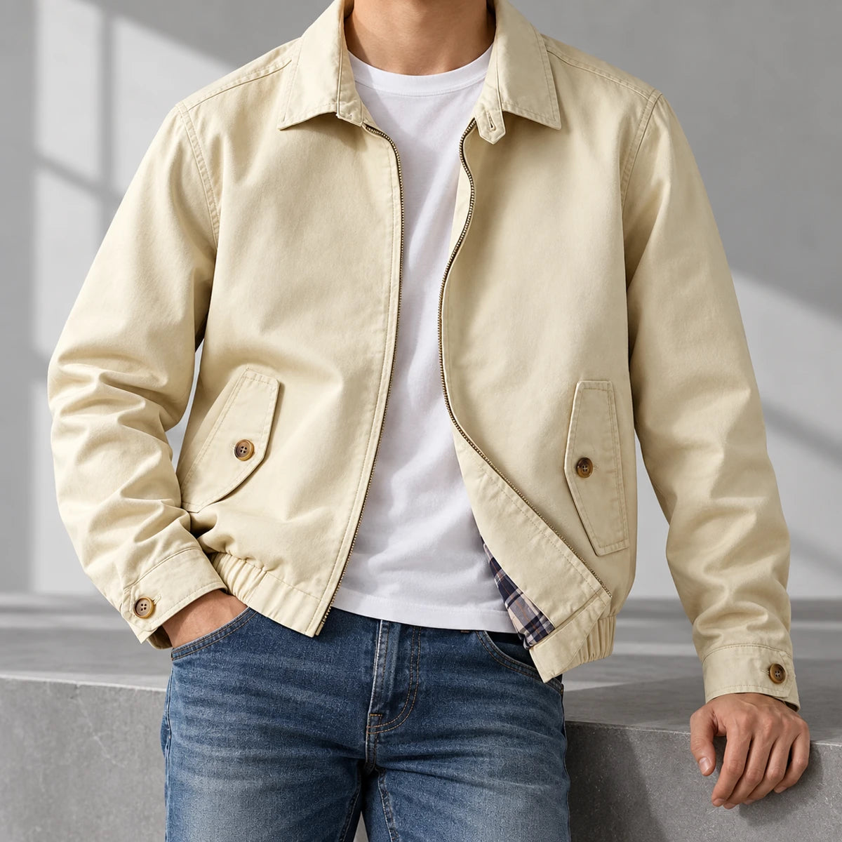 Cotton Harrington Jacket | Felix Cream neck-down wearer casually leaning on gray studio ledge