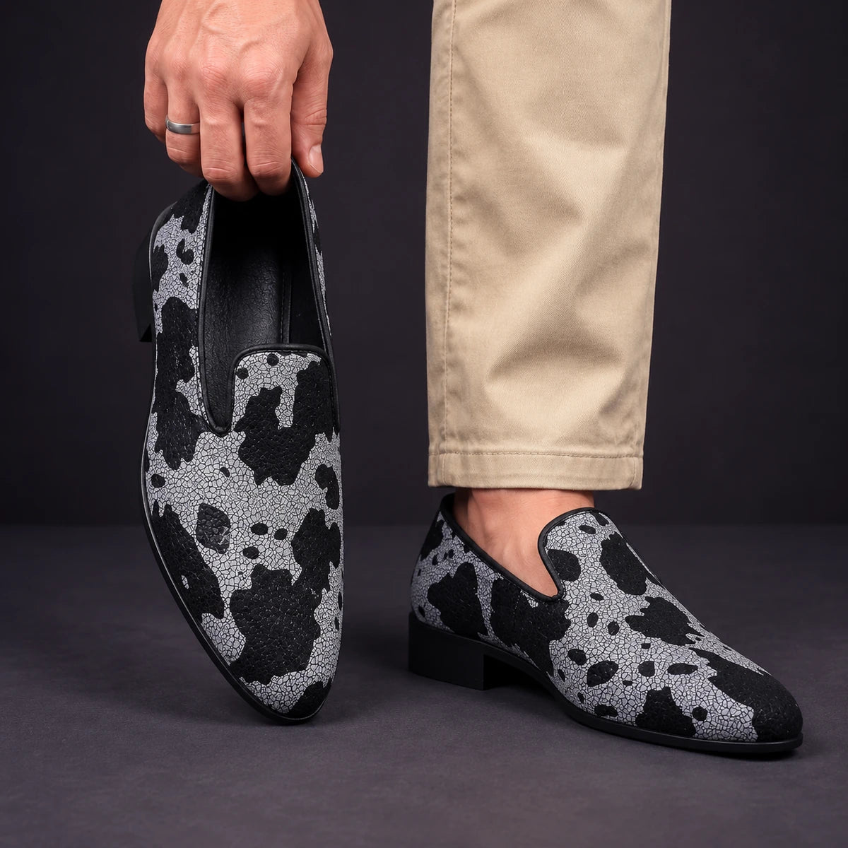 Printed Loafers | Valentin Gray model holding shoe by heel opening beside matching worn shoe