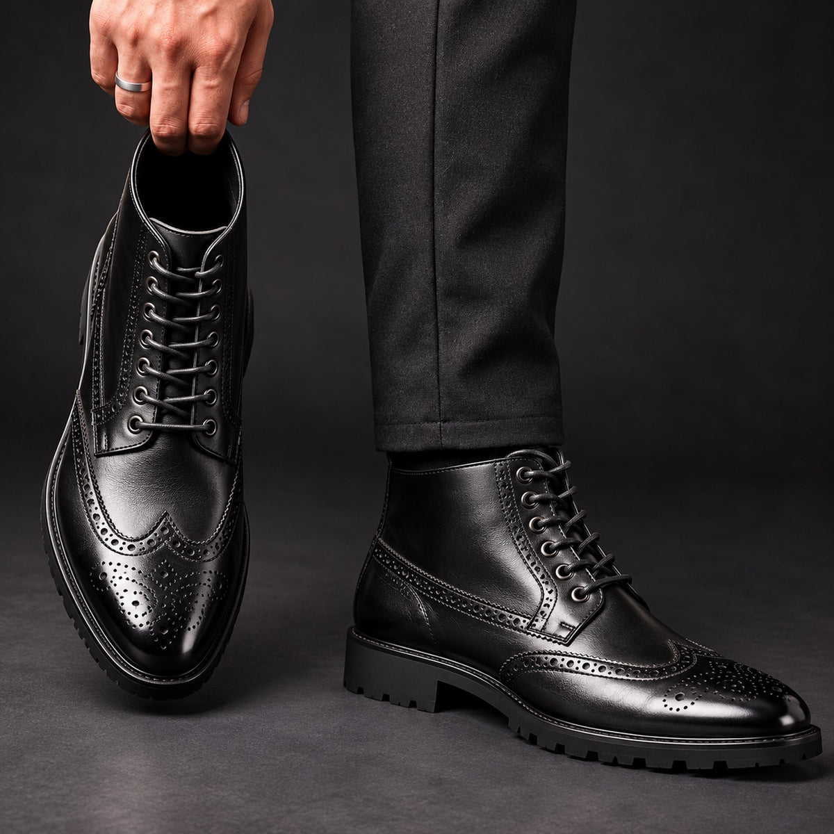 Vittorio Brogue Lace-Up Boots in Black hand editorial
