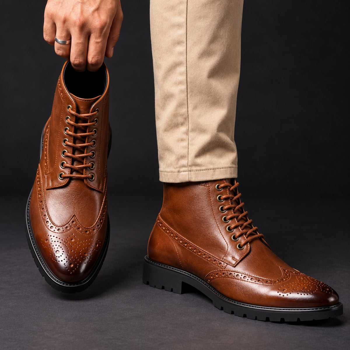 Vittorio Brogue Lace-Up Boots in Brown hand editorial
