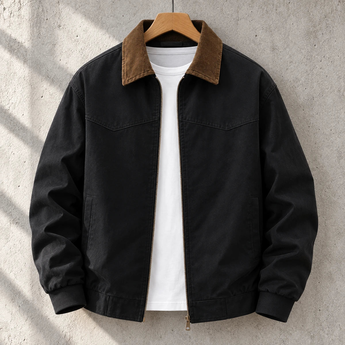 Cotton Jacket | Bennett Black front garment hanging on simple wooden hanger on concrete wall