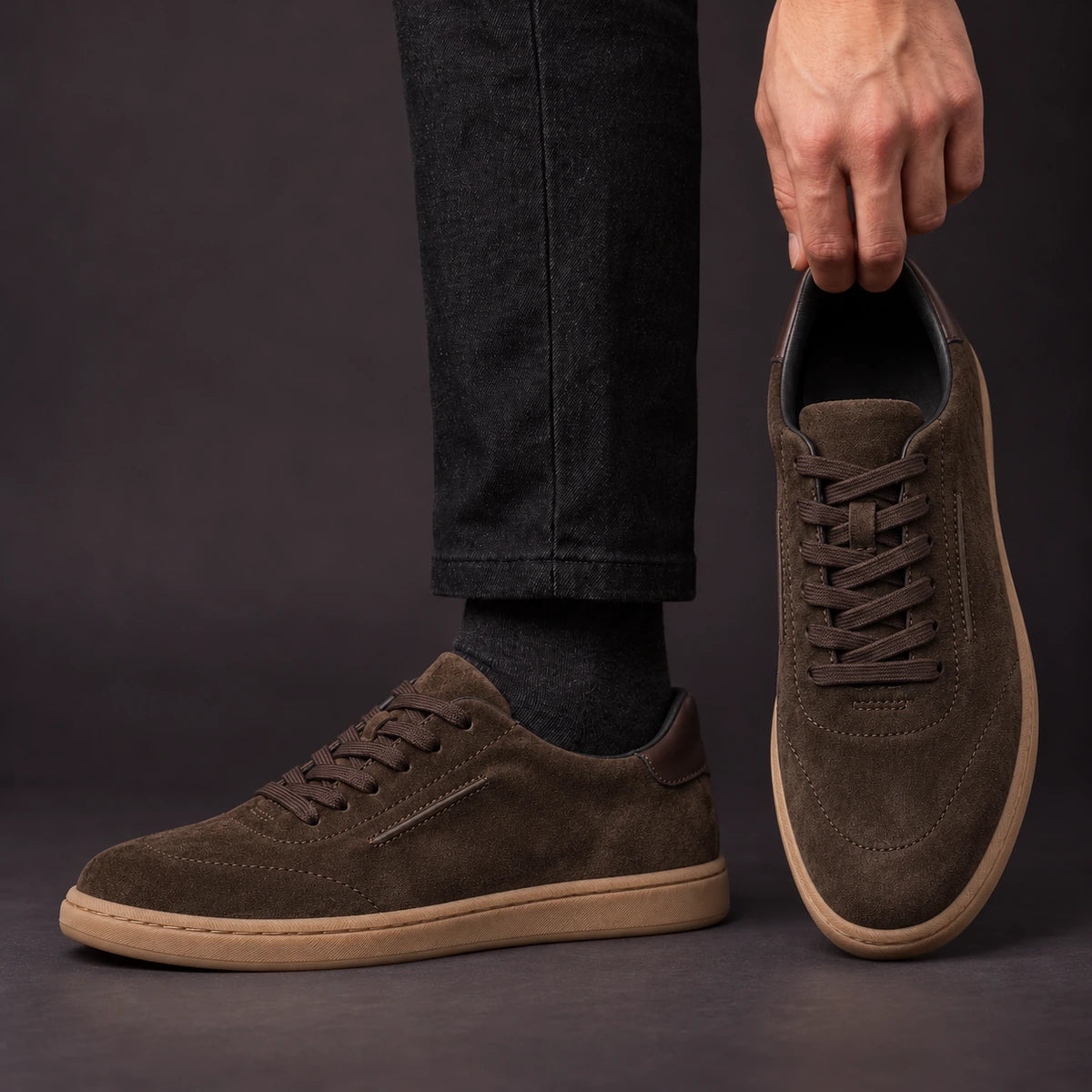 Leather Sneakers | Willem Brown model holding shoe by heel opening beside matching worn shoe