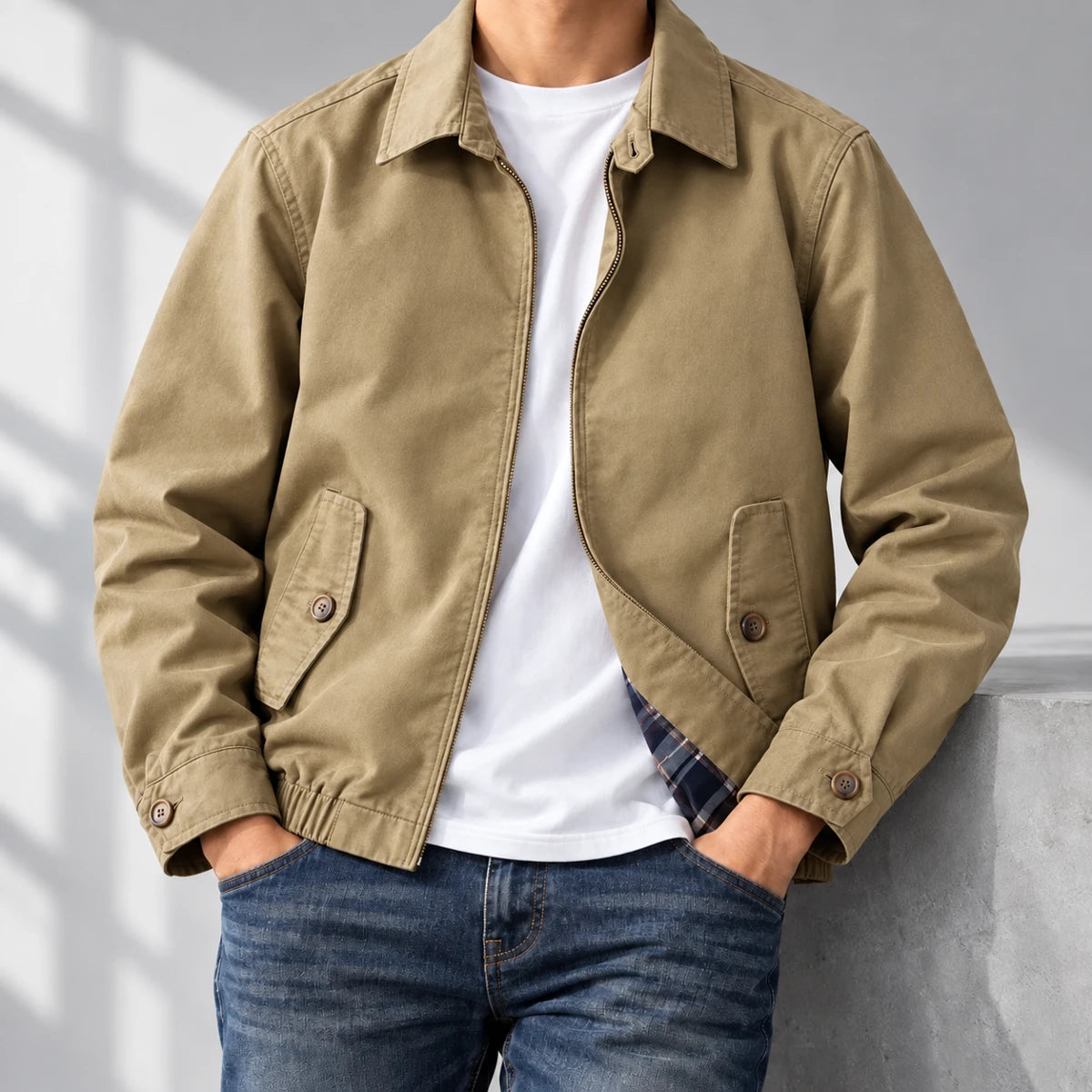 Cotton Harrington Jacket | Felix Brown neck-down wearer casually leaning on gray studio ledge