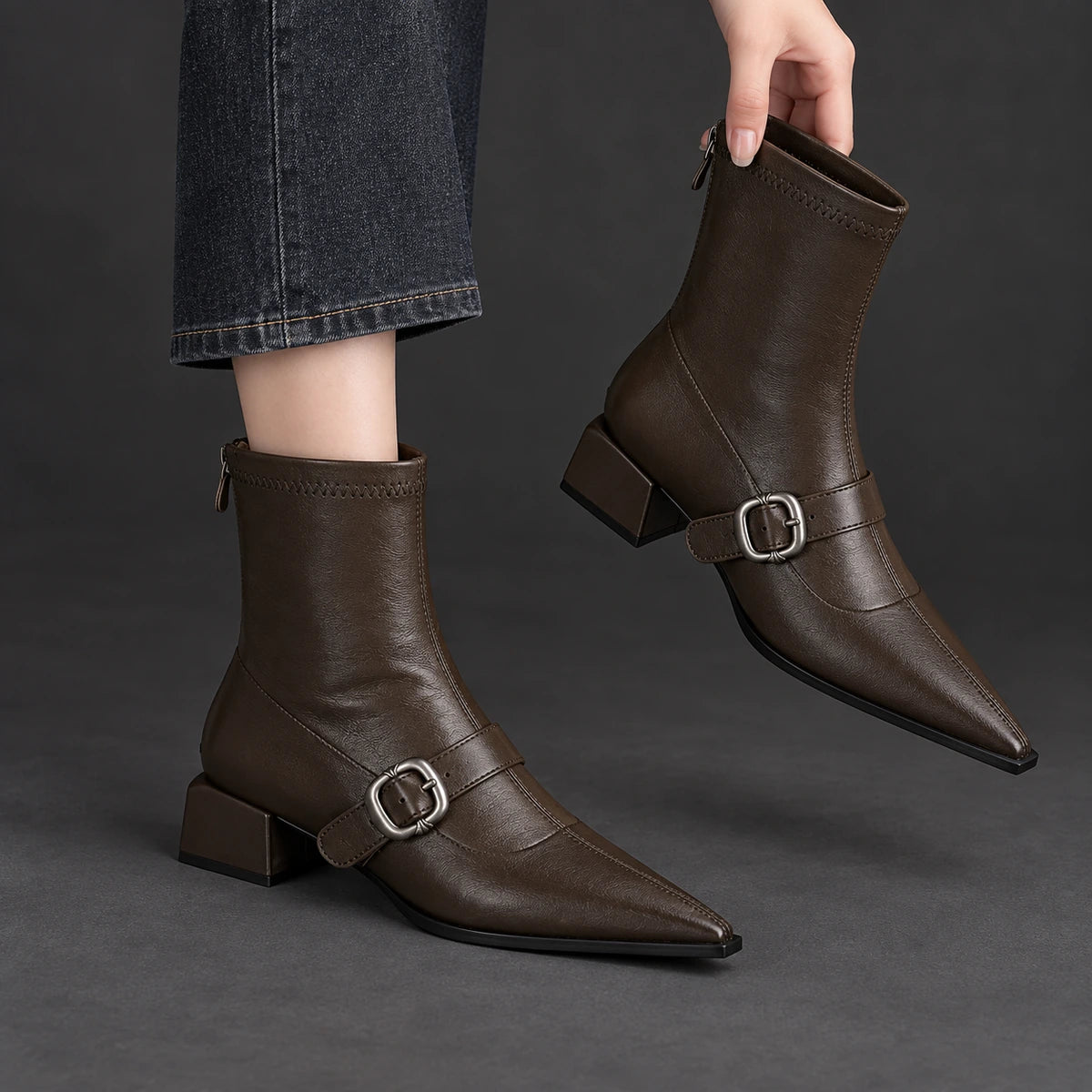 Pointed Toe Buckle Ankle Boots | Serena in Dark Brown, one boot held beside its worn matching boot