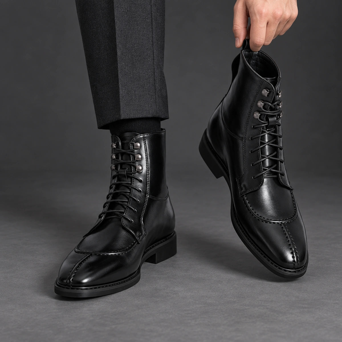 Split Toe Lace Up Boots | Lorenzo in Black, one boot held beside matching worn boot